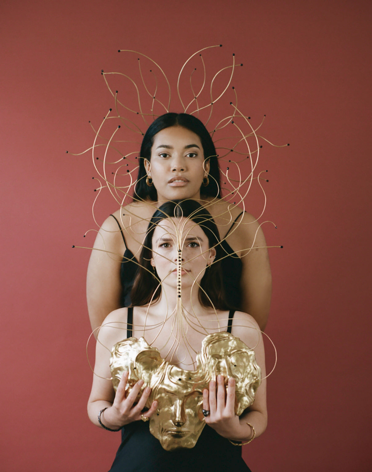 Models wearing symmetrical designed headpieces and jewellery