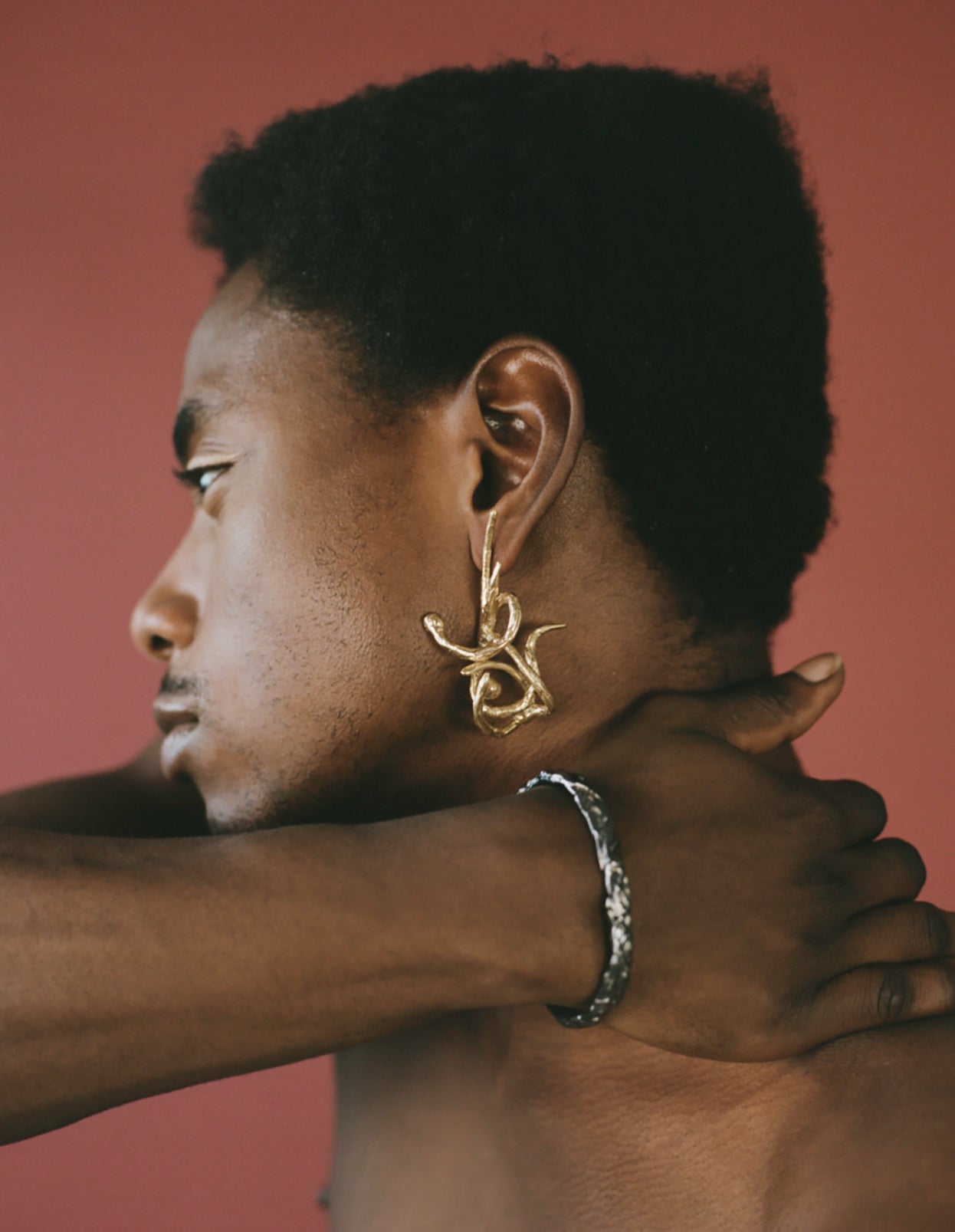 Model wearing statement gold earring