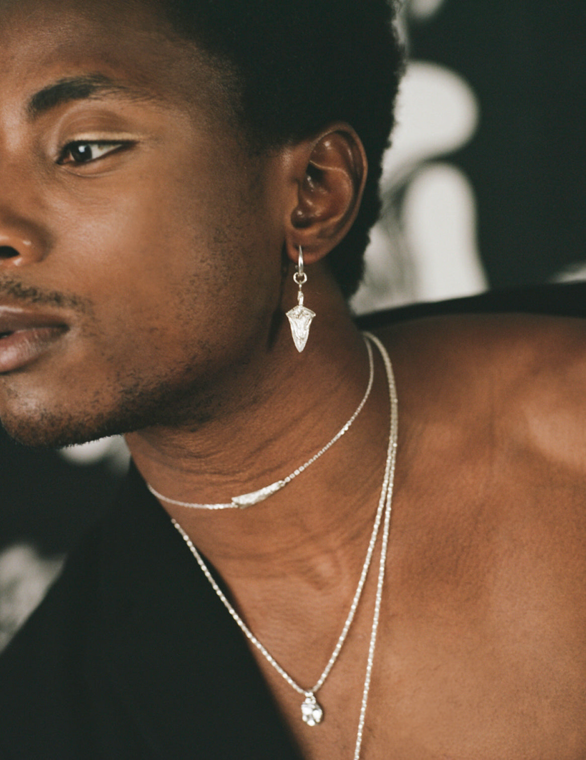 Model wearing sterling silver earring in the shape of a spear