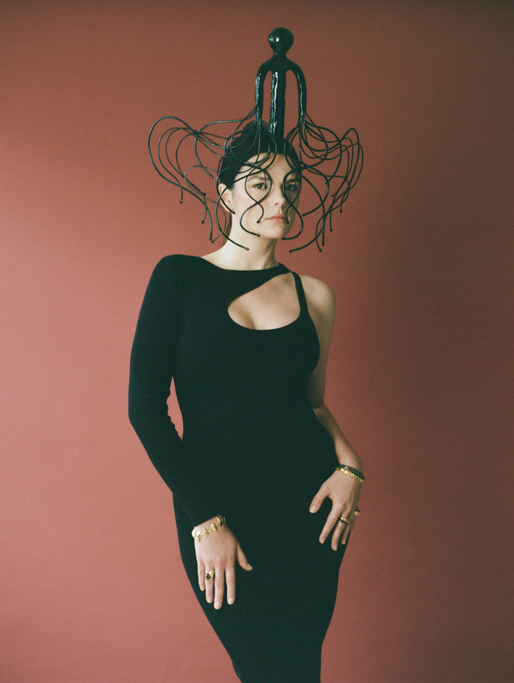 Model wearing slick black dress and headpiece based on Irish history