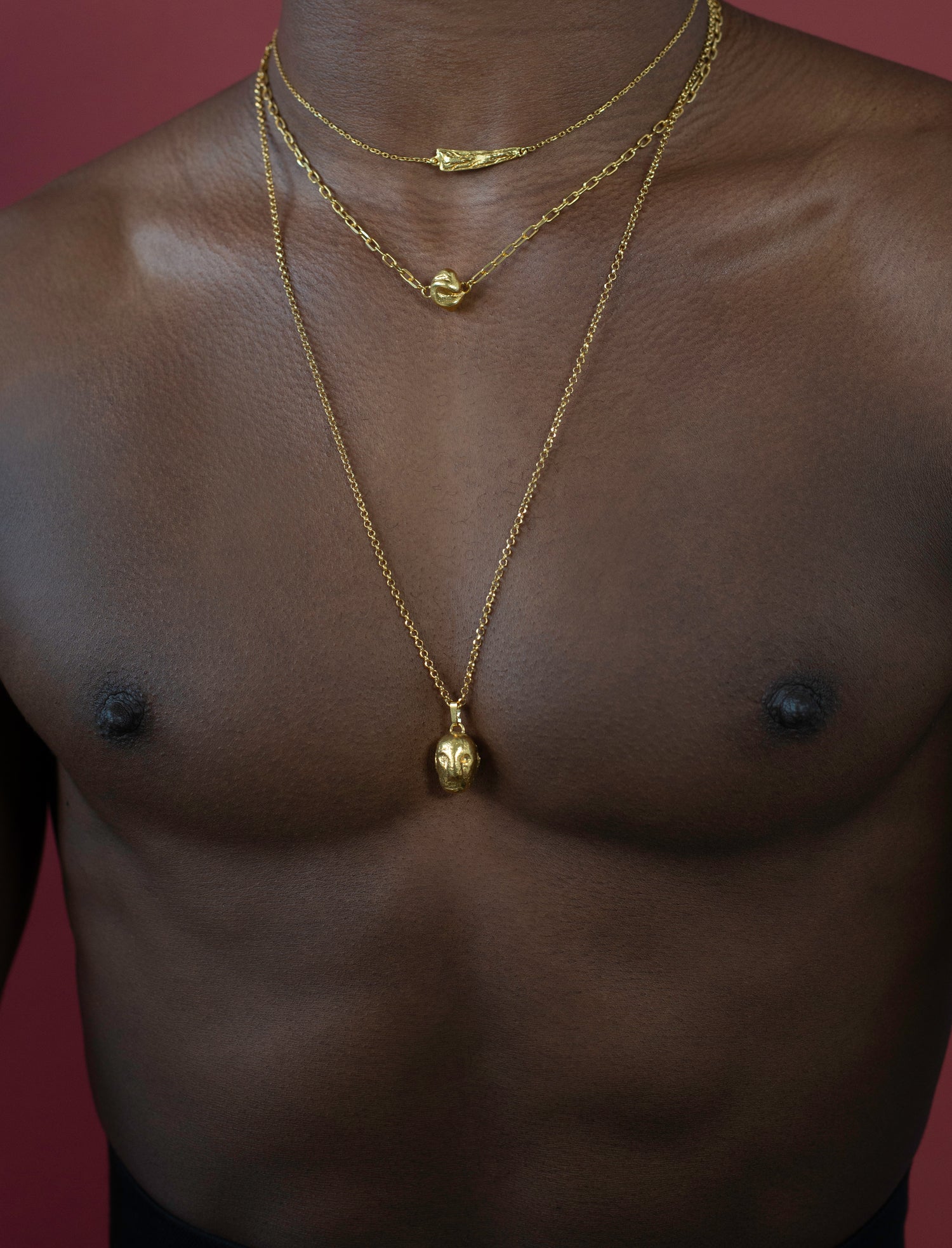 Model wearing layered gold vermeil necklaces inspired by ancient Ireland