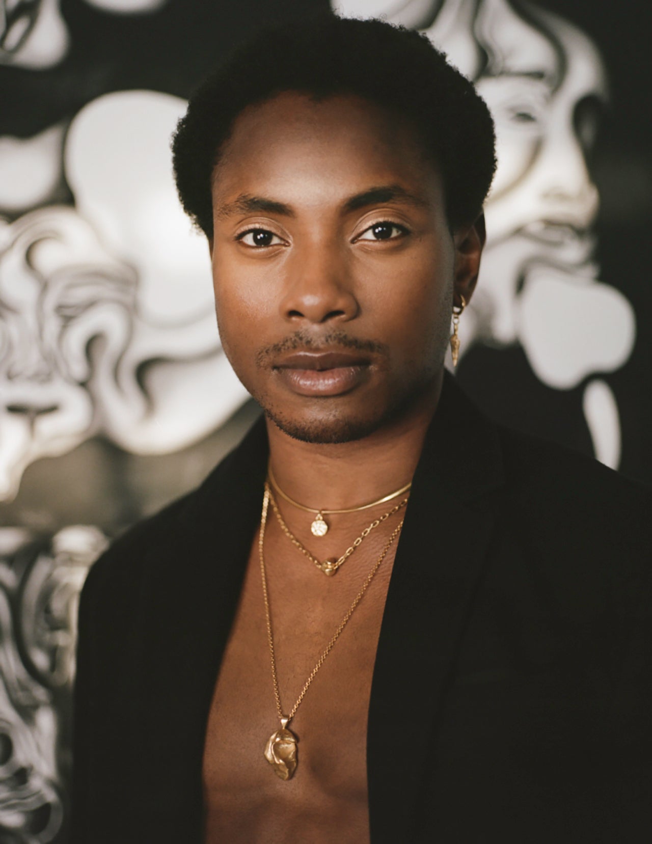 Model wearing layered gold Richard Murphy Necklaces