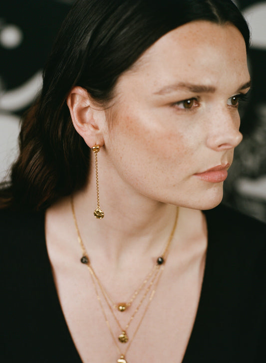 Model wearing handcrafted Richard Murphy earrings and necklaces.