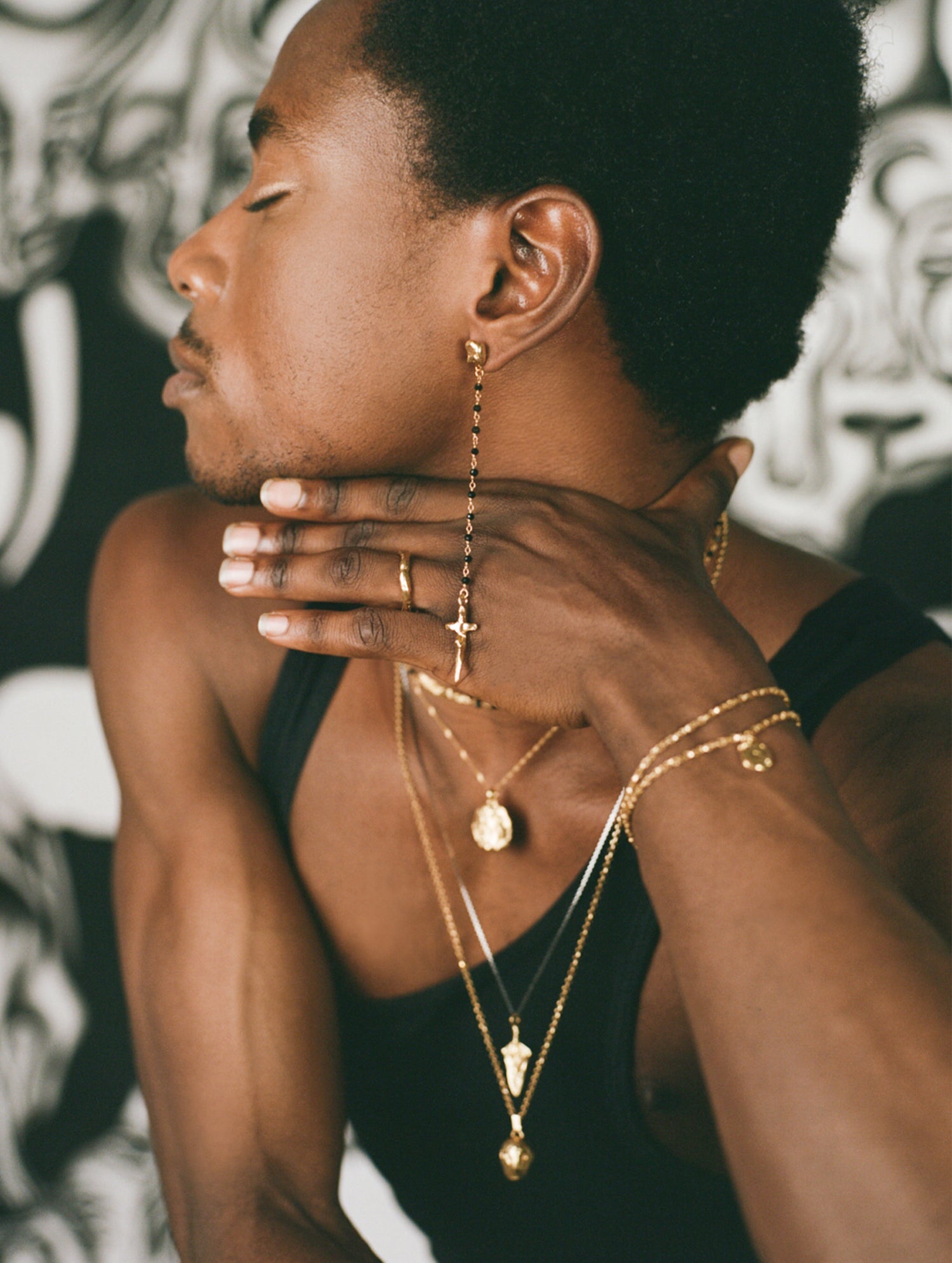 Model wearing black beaded rosary chain earring and Richard Murphy Jewellery