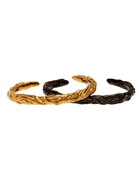 Black and gold bangles with organic Irish stone carving shapes
